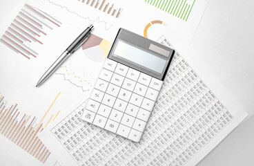 Naklejka na ściany i meble Financial accounting. White calculator and financial documentation on white background