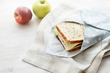 Whole grain sandwich wrapped in reusable bag. Zero waste ecologic concept