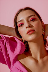 Close up beauty portrait of young beautiful woman with pink, fuchsia color eyeshadow makeup,...