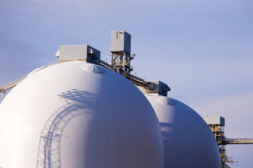 Two 45-meter white grain silos built in 2013 in the Quebec City port along the St. Lawrence River,...