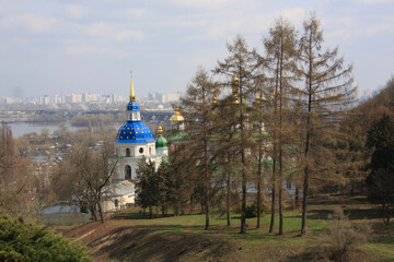 Orthodox church is sunlit in the middle of spring park