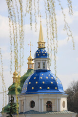 Fototapeta na wymiar Orthodox church is sunlit in the middle of spring park