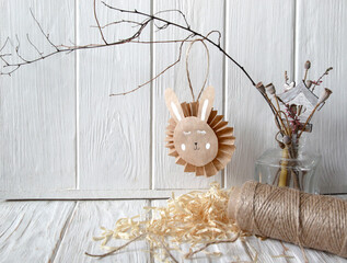Easter bunny made of paper on a branch, do-it-yourself composition with natural materials