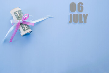 calendar date on blue background with rolled up dollar bills pinned by blue and pink ribbon with copy space. July 6 is the sixth day of the month