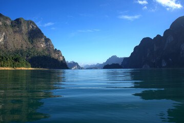 Fototapeta na wymiar Cheow Lan Lake and Both of Mountains in Khao Sok National Park in Surat Thani Province, Southern Thailand