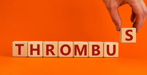 Medical and and thrombus symbol. Wooden cubes with the word 'thrombus'. Beautiful orange...