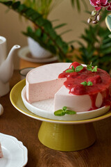 strawberries mousse with strawberries sauce. Wood background. Side View. Selective focus, close-up. Strawberries, mint,  coffee and home flowers. 