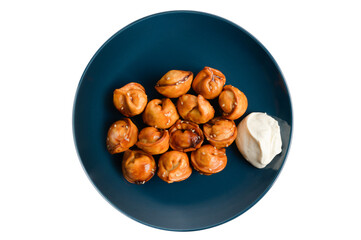 chinese cuisine traditional fried dumpling Jiaozi with white sour cream sauce on blue dish on white isolated copy space background
