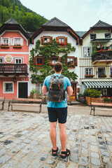 traveler with backpack at central city square in hallstatt