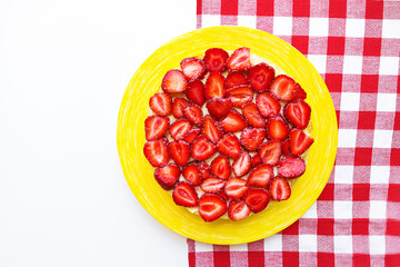 Bright and delicious strawberry cake on a red napkin in a cage