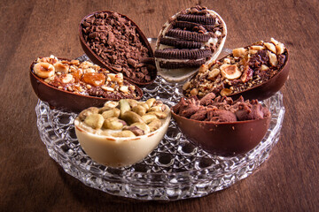 Six mini stuffed easter eggs on a glass plate on a wooden table.