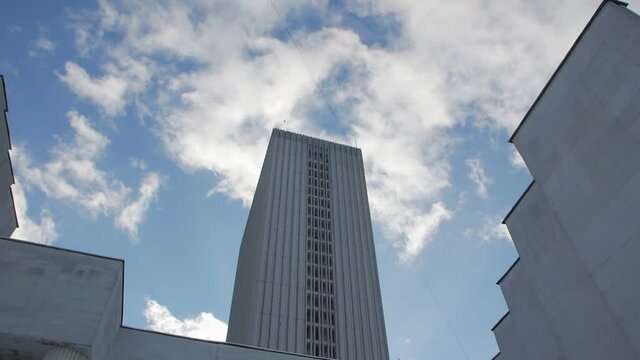 Old concrete building blue sky birds push out backward camera movement