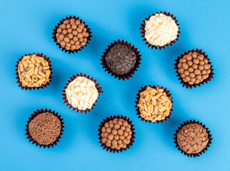 Typical brazilian brigadeiros, various flavors over colorful background