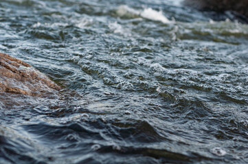 Background, top view, rapid flow river with dark blue water and white foam waves