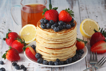 A stack if home-made pancakes with berry	