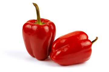 two red sweet bell peppers isolated on white background