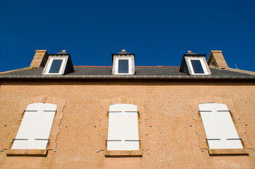 stone house facade over blue sky