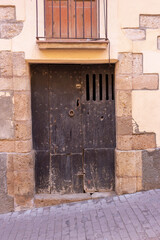Old wooden door with stone arch