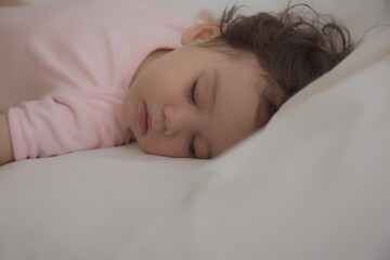 Adorable cute child sleeping on bed at night with sweet dream in bedroom Lovely toddler child get deep sleep and get relax and happy during lay down on bed Little toddler girl get good sleep