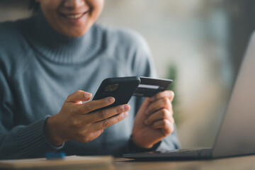 woman makes a purchase on the Internet on the smart phone with credit card, online payment,...