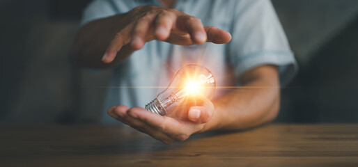 businessman holding light bulb, Creative new idea. Innovation, brainstorming, inspiration and solution concepts..
