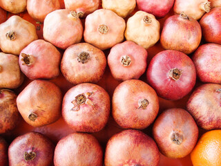 ripe pomegranate fruits on a wooden table