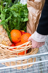 Woman getting her shopping basket out of the cart