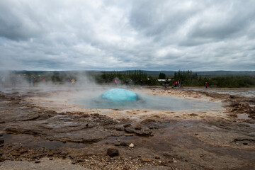 Geyser moments before eruption at the Strokkur geyser in the Geysir area, Iceland, Europe