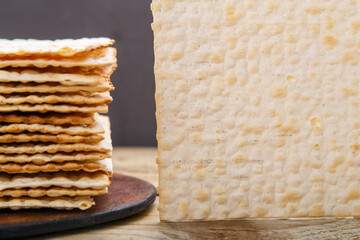 Matza sheets on a round stand on a wooden table. copy space.