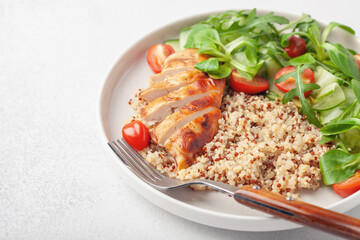 Turkey fillet or chicken, quinoa and vegetable salad in plate. Diet concept food.