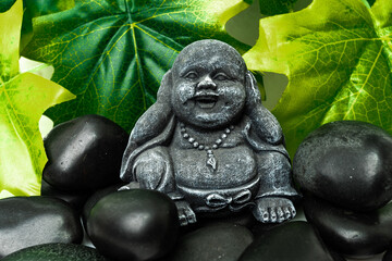Obraz premium Buddha and stack of black basalt stones