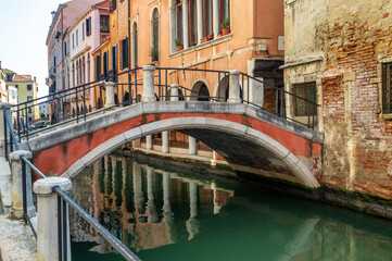 Fototapeta na wymiar Venice, Italy. Low stone bridge over the canal