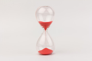 Crystal hourglass on light background as a concept of passing time for business term, urgency and...