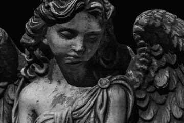 Sad eyes of sad angel. Fragment of an ancient statue. Death, pain and end of life concept.
