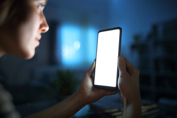 Woman using and showing blank phone screen in the night