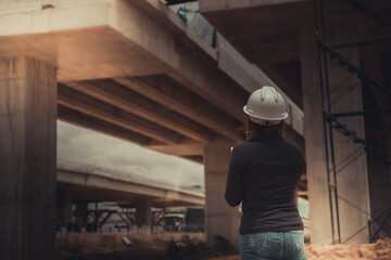 Engineer woman working at site of bridge under construction