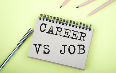 Career vs Job text on the notebook with pen on yellow background