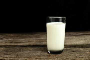 Almond milk with a wooden table on dark background. Healthy food. Food and drink concept. Diet, Health.