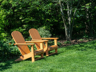 Pair of Adirondack chairs in a garden.