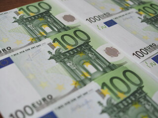 Obraz na płótnie Canvas Many new 100 Euro banknotes are neatly arranged in rows