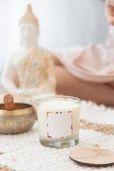 meditation space with candles and woman in background