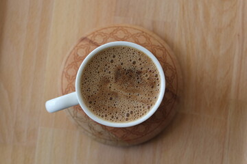 Three cups of Turkish coffee on a wooden bamboo tray.
Mortar brown in white cups