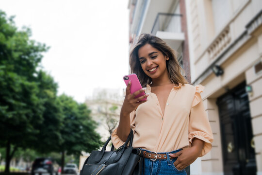 Young woman using her mobile phone.