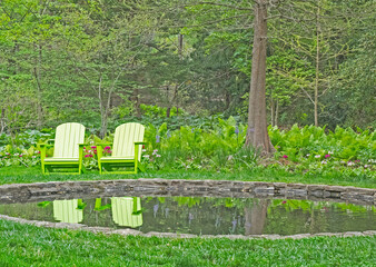 USA, Pennsylvania, Wayne and Chanticleer Gardens with small pond and green chairs