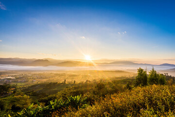 Landscape view of Sunrise over mountains with fog faded.