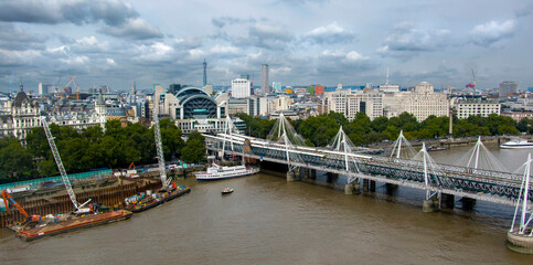 Aerial view of Hungerford Bridge, a steel truss railway bridge, flanked by the Golden Jubilee...