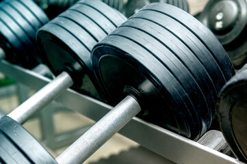 Row dumbbell. metal Dumbbells on rack for strength training in gym