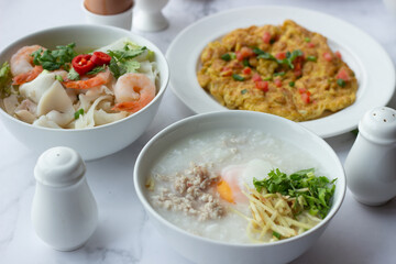 American and Thai breakfast set on the marble background