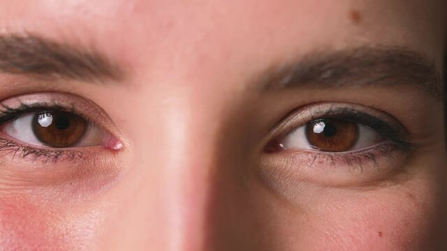 Close up of Womans eyes, Girl opening her Beautiful brown eyes. Natural Beauty. Gorgeous woman with long Eyelashes and Attractive Appearance. Slow motion.