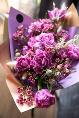 A fragrant bouquet of purple and pink flowers for a gift in paper.